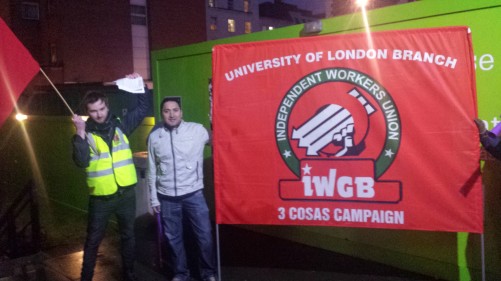 Martin (left) holding an IWW flag, alongside an IWGB member.